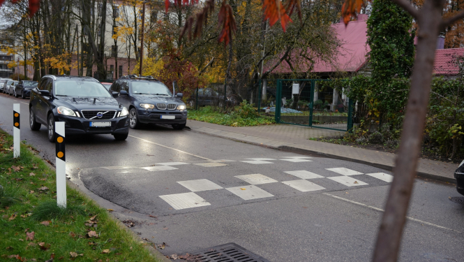 Automašīna brauc pāri ātrumvalnim