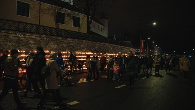 Cilvēki liek svecītes 11.novembra krastmalā