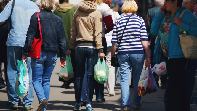 Cilvēki ar iepirkumu maisiņiem