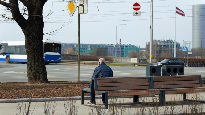 Cilvēks sēž uz soliņa