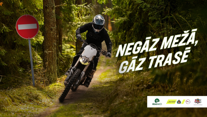 Cilvēks uz motocikla mežā