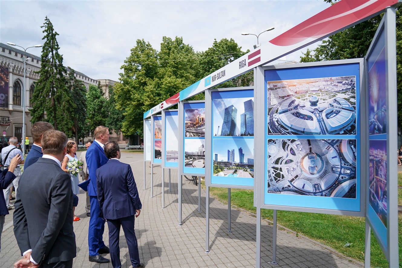 Rīgas domes priekšsēdētāja vietnieks Edvards Smiltēns un pilnvarotais Kazahstānas Republikas vēstnieks Latvijā Timurs Primbetovs Līvu laukumā atklāj fotoizstādi par Kazahstānas galvaspilsētu Nursultanu