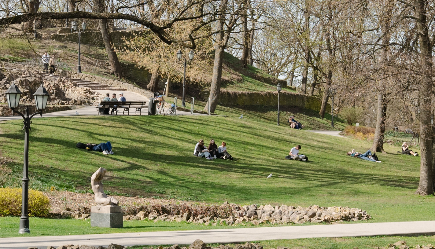 Cilvēki sēž zālītē Bastejalnā